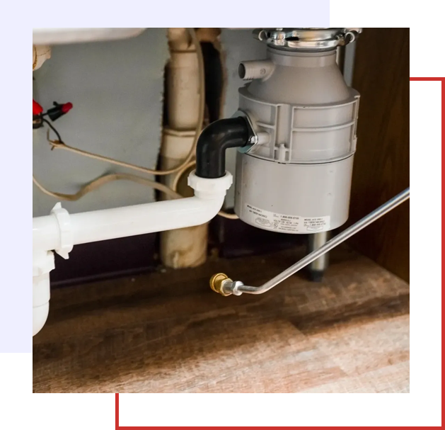 A close up of the pipes and valves in a kitchen