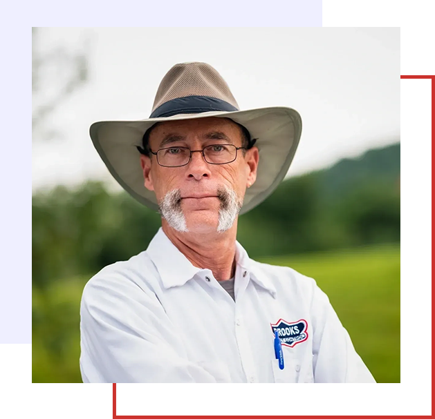 A man with a beard and hat on